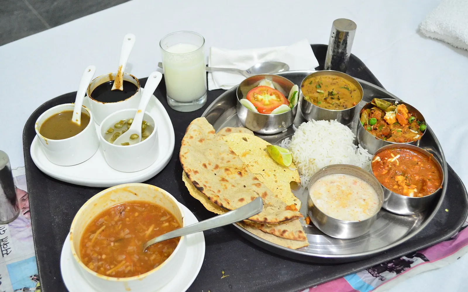 A North Indian vegetarian thali with roti, rice, dal, vegetables and curd